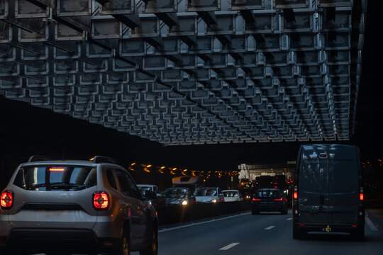Driving in tunnel in heavy traffic on ring road of capital of France, traffic jam problems in Paris