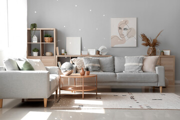 Interior of modern living room with grey sofas and disco ball on coffee table