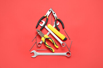 Christmas tree made of repair tools on red background