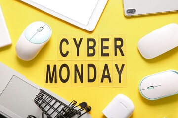 Text CYBER MONDAY made of letters and different gadgets on yellow background
