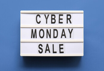 Board with text CYBER MONDAY SALE on blue background