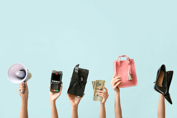 Female hands with women accessories, money, gift box, megaphone and payment terminal on blue background. Black Friday sale