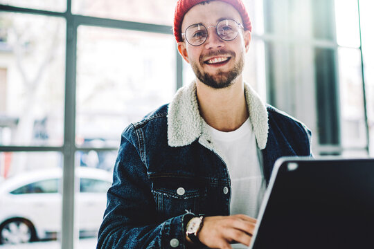 Caucasian smiling freelancer sitting with digital tablet and keyboard accessorise smiling to camera