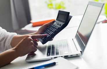 hands with calculator and laptop