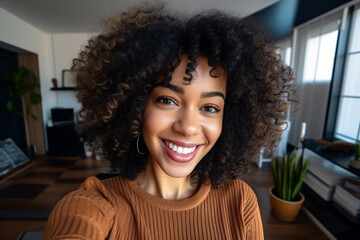 A young african american woman is is making a selfie while smiling with a profesional camera in a modern living room a low tech social media woman