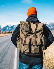 Guy wanderlust looking forward while exploring wild nature in hiking tour