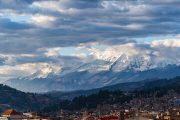 Magnificent sunset view of mountain peaks covered with snow at sunset in the Peruvian city of Huaraz.