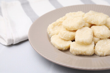 Plate of tasty lazy dumplings on white table, closeup