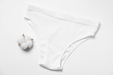 Stylish women's underwear and cotton flower on white background, flat lay