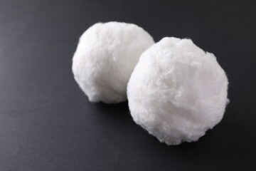 Balls of clean cotton wool on grey background, closeup. Space for text