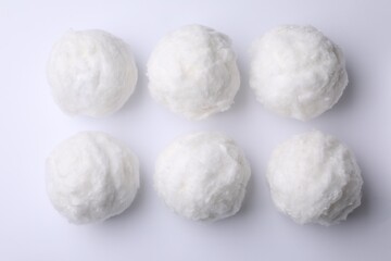 Fototapeta na wymiar Balls of clean cotton wool on white background, top view