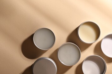 Different lip balms on beige background, flat lay - obrazy, fototapety, plakaty