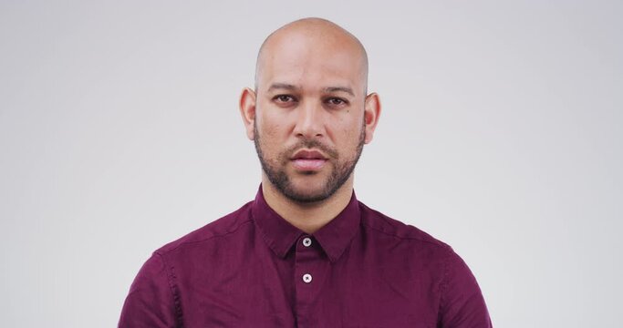 Serious, face and man in studio with blank expression, unsure or concerned against grey background. Numb, portrait and male model with neutral, staring or doubt while posing skeptical and isolated