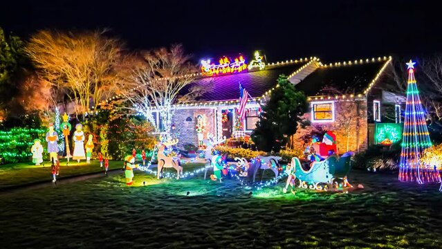 Small American home exterior decorated with colorful festive holiday lights