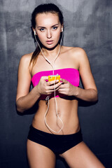 Active Woman standing with Headphones in Indoor Studio - 670309543