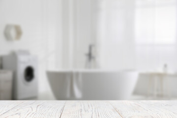 Empty white wooden table in bathroom. Space for design