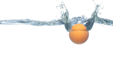Ping Pong ball falls into water and creates air bubbles on surface. PingPong Table Tennis orange ball drop hit smash to clear water and deep to bubble. White background isolated freeze motion - obrazy, fototapety, plakaty