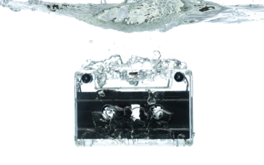Cassette retro vintage Tape fall into clear water with air bubble. Black retro vintage cassette magnetic tape drop to wash old time. White background isolated freeze element