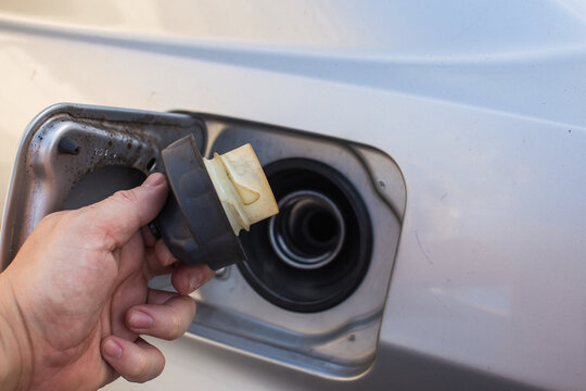 Hand refilling the car with fuel at the refuel station