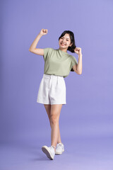 Portrait of beautiful Asian woman posing on purple background