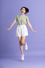 Portrait of beautiful Asian woman posing on purple background