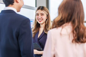 Millennial Asian professional successful young male female businessman businesswoman management with secretary in formal business suit outfit standing smiling discussing with customer in meeting room