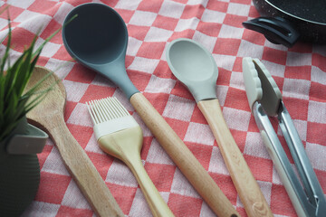  wooden cutlery fork and spoon on a chopping board on table 