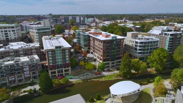 Downtown architecture of Greenville city in South Carolina. View of the Reedy River and apartment buildings. American travel destination.