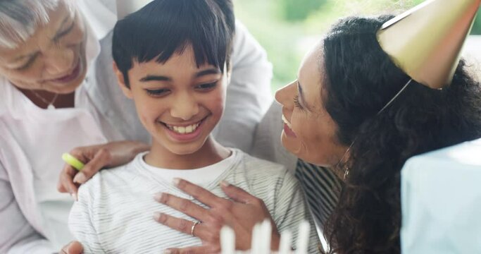 Birthday, party and happy family child celebrate, excited and childhood memory event with boy, mother and grandmother. Grandma, youth and mom hug young kid for celebration, congratulations and kiss