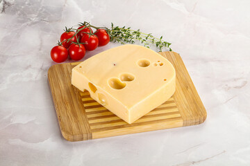 Maasdam cheese brick over board