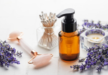 Fototapeta na wymiar Essential oil, fresh lavender flowers, aroma candle and jade stone.