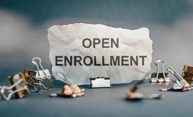 A piece of torn paper with text on it OPEN ENROLLMENT