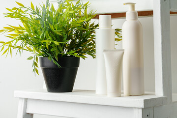 White blank plastic cosmetic containers in a bathroom close up