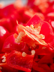 Red hot Chili fruits cut on plate in close up view