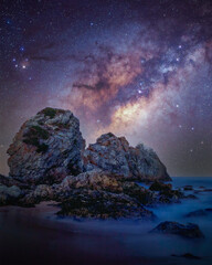 Starry night sky, Milkyway over the Camel Rock in Australia, Beach with a lot of stars in the sky
