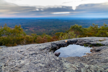 Sunrise on a mountain with a reflective puddle