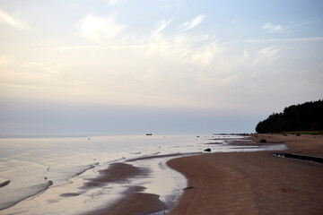 Amazing calm scenery of a blue sky and tranquil sea with light fog above, selective focus
