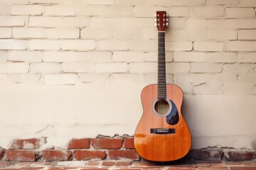 an acoustic guitar leaning against a wall