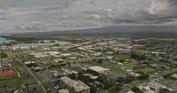 Kahului Maui Hawaii Aerial v9 drone flyover town center overlooking at townscape, Kanaha pond, main airport and island landscape with stormy clouds in the sky - Shot with Mavic 3 Cine - December 2022