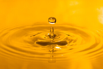 yellow drop oil , Liquid gold oil drop ripple background.