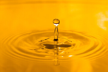 yellow drop oil , Liquid gold oil drop ripple background.