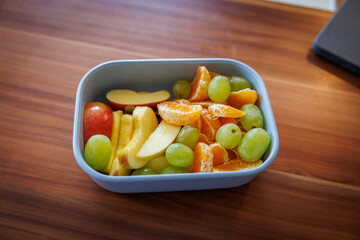 in a bowl lies fresh cut fruit of different fruits