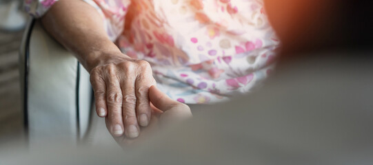 Parkinson disease patient, Alzheimer elderly senior, Arthritis person's hand in support of nursing family caregiver care for disability awareness day, National care givers month, aging society concept - obrazy, fototapety, plakaty