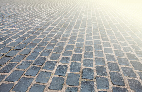Surface is paved with road tiles of different sizes as texture