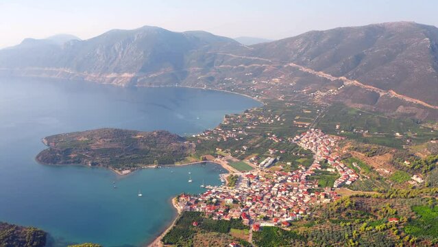 4k drone flight moving to the side footage (Ultra High Definition) of Palaia Epidavros, small town in the Argolis prefecture of Peloponnese, Greece. Spectacular summer seascape of Mediterranean sea..