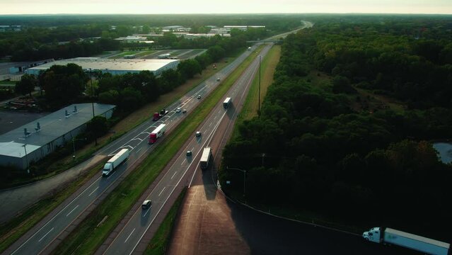 following a CDL semi truck driver entering the ramp of highway, Sunset aerial