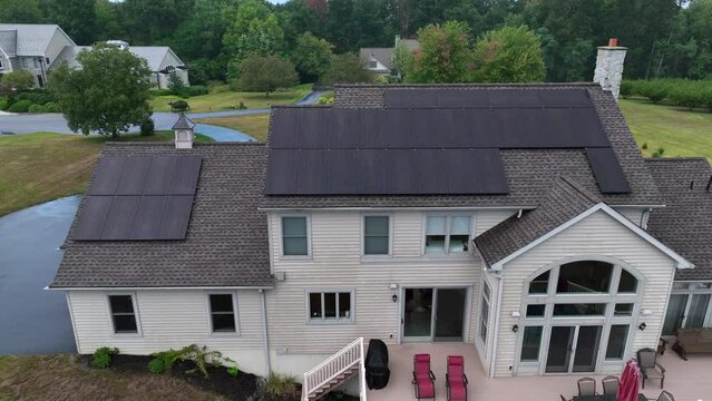 Solar panels produce no energy during rainy day. Aerial establishing shot of ineffective solar power array. Downfall of renewable energy. American house.