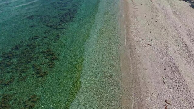 Slow Motion Drone View of Gentle Waves Crashing on Ipil Bay, Philippines