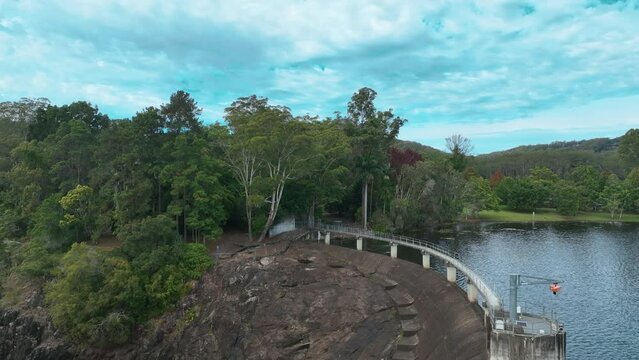 Aerial curves over Wappa Dam and forest ringed lake by Yandina Queensland