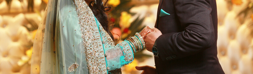 Pakistani Indian Bride and groom Holding hand at their wedding day	